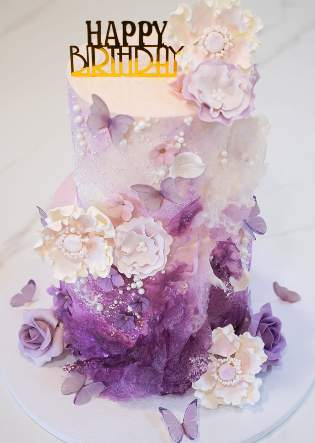 Lavender birthday cake with sugar flowers and butterflies
