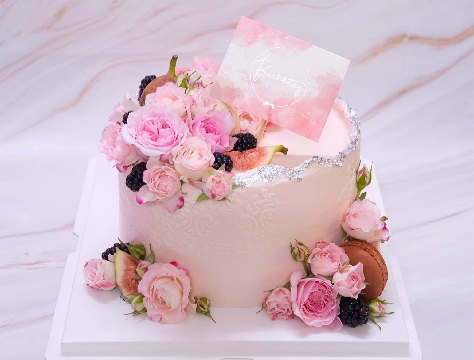 Pink cake with roses and berries